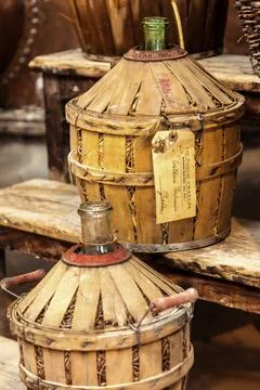 A row of old-fashioned copper containers sit on a wooden platform museum of.. Stock Photos