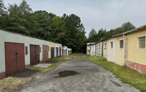 Row of old garages along an access lane. Stock Photos