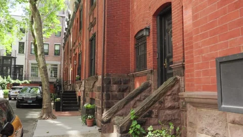 Row of old red brick brownstone homes in the Manhattan borough of New York c Stock Footage 242365993