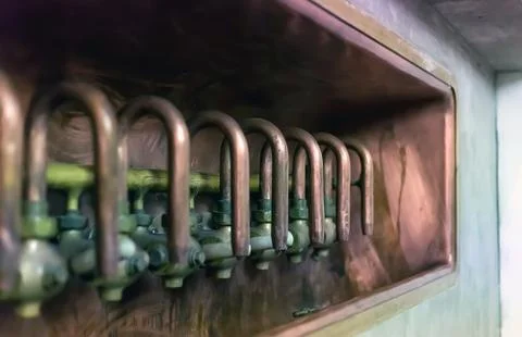 Row of old shiny copper taps at the brewery production Stock Photos