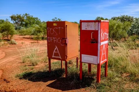 A row of old, weathered post office boxes stands in the Australian outback Stock Photos