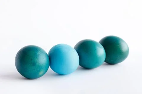 Row of ombre blue Easter eggs isolated on white background Stock Photos