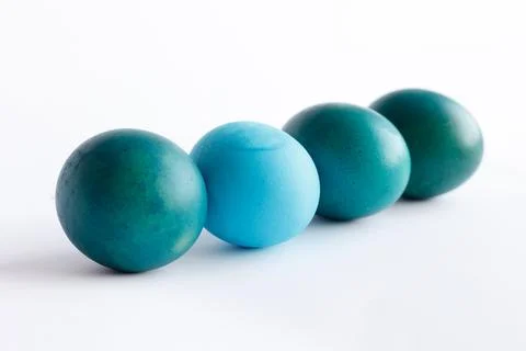 Row of ombre blue Easter eggs isolated on white background Stock Photos