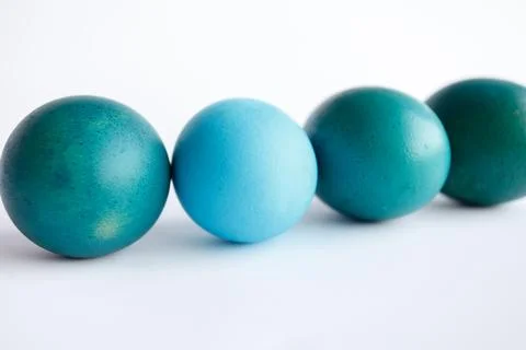 Row of ombre blue Easter eggs isolated on white background Stock Photos