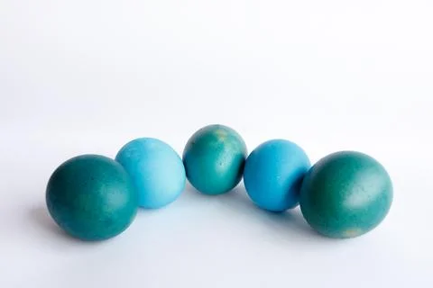 Row of ombre blue Easter eggs isolated on white background Stock Photos