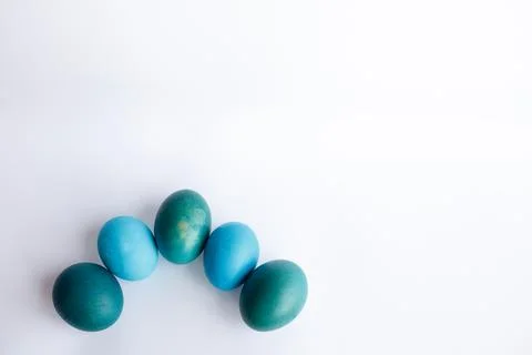 Row of ombre blue Easter eggs isolated on white background Stock Photos