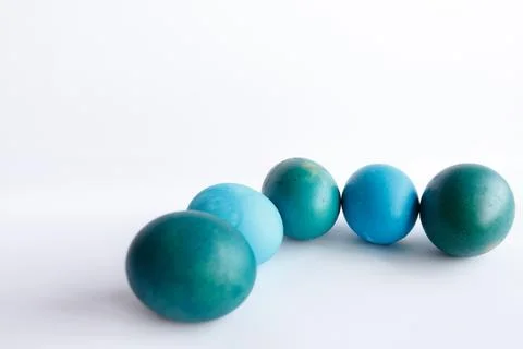 Row of ombre blue Easter eggs isolated on white background Stock Photos