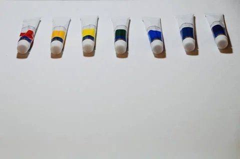 Row of Paint Tubes on White Surface with Copy Space Stock-Fotos