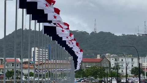 Row of Panama flags waving with city in background Stock Footage 125571978