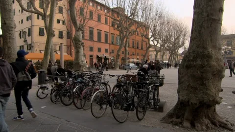 Row of Parked Bicycles at Edge of Plaza in Lucca, Tuscany Stock Footage 101217505
