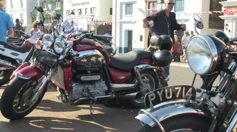 Row of parked motorbikes man puts on coat Stock Footage 36815441