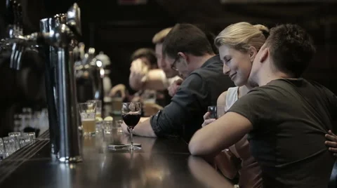 Row of people drinking at a bar Stock Footage 58134341