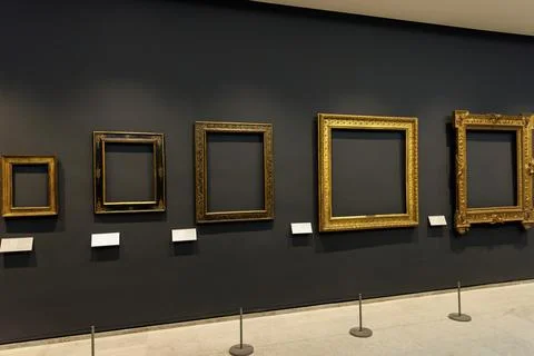 A row of picture frames on a museum wall Stock Photos