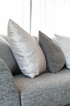Row of pillows on grey sofa Stock Photos