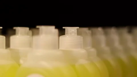 Row of plastic bottles of cleaning product on a store shelf. Many bottles with Stock Footage 273281203