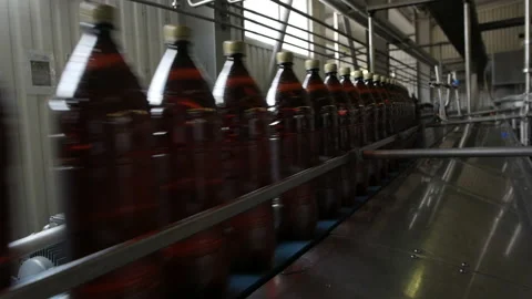Row of plastic bottles on a line, close up. Video stock 116973525