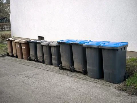 A row of plastic containers for sorting waste on the street 스톡 사진