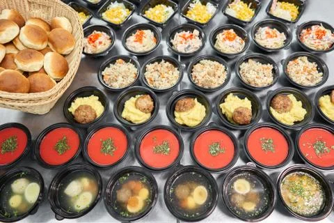 Row of plastic disposable lunch box with healthy natural food. Soups, cream soup Stock Photos