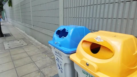 Row of Plastic Recycling and Garbage Bins on Urban Sidewalk Stock Footage 343593081