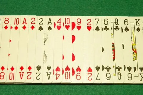 Row of poker cards on poker table. Stock-Fotos