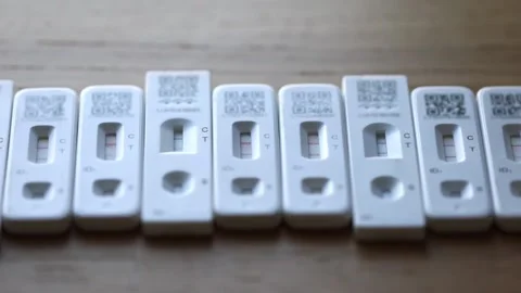 Row of positive Coronavirus lateral flow tests.  Zoom in Stock Footage 169981885