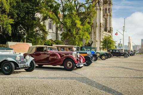 Row of pre-war or classic cars on sunny day in historic setting Stock Photos
