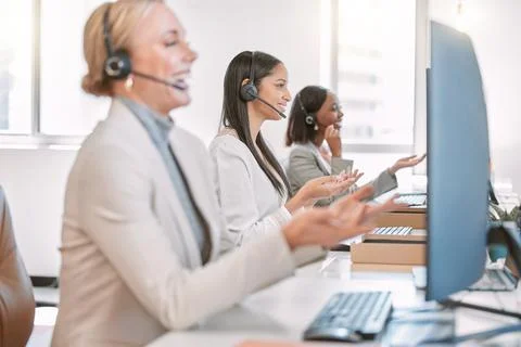 A row of problem solvers. a group of female call center agents wearing headsets 스톡 사진