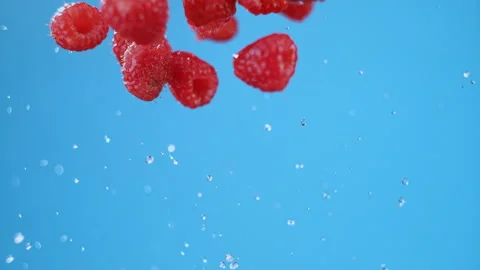 Row of raspberries flying, separating in air after being launched. High Stock Footage 279528973