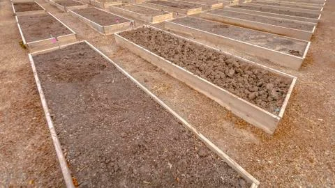 Row of rectangular raised garden beds with faucets Fotos de archivo