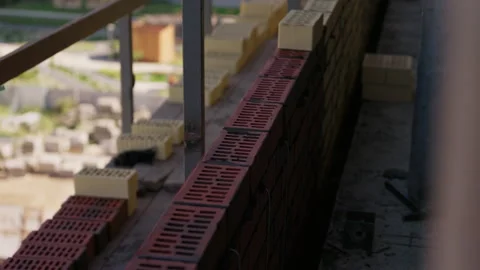 Row of red bricks laid for exterior masonry wall construction Stock Footage 346549912