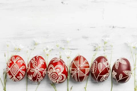 Row of red colored Easter eggs. Pysanka on white Stock Photos