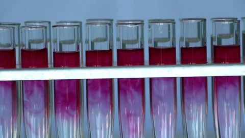 The row of red dye filled glass vials dolly shot Stock Footage 77209129