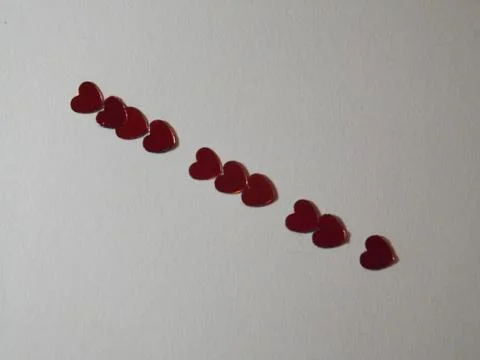Row of red hearts on a plain background Stock Photos