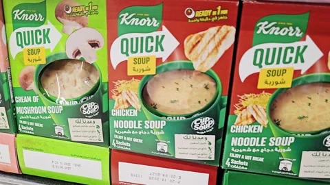 A row of red Knorr Quick Soup boxes on a store shelf, featuring Chicken Noodle Stock Footage 340096622