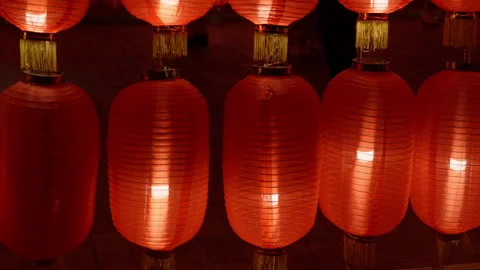 A row of red lanterns flickered in the wind Stock Footage 257992406