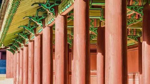 Row of red pillars supporting ornate traditional asian architecture Stock Photos