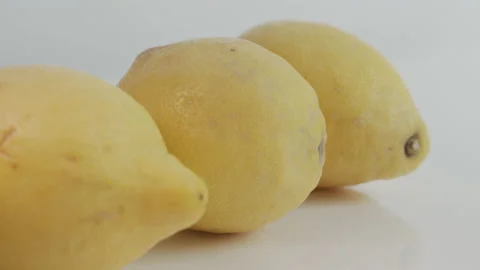 Row of ripe lemons on white background 4K sliding video Stock Footage 161535503
