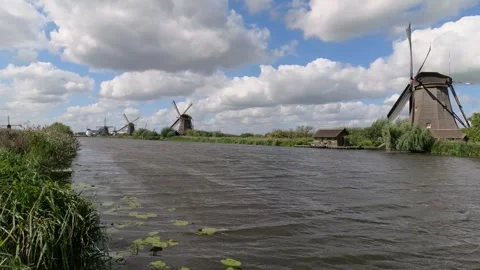 Row of running Dutch windmills with turning sails at Kinderdijk, Netherlands Stock Footage 345710253