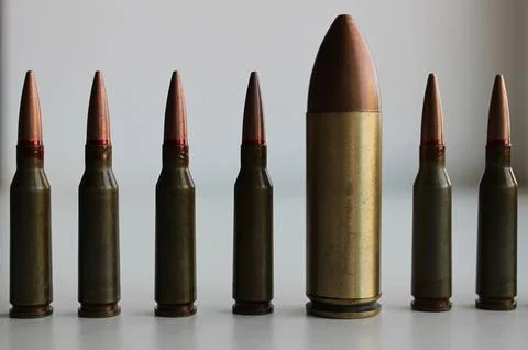 Row With Same Ammunition And Huge Cartridge In Line Stock Photos