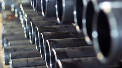 Row seamless steel tube stack warehouse rack closeup. Metallurgy plant storage. Stock Footage 345677006