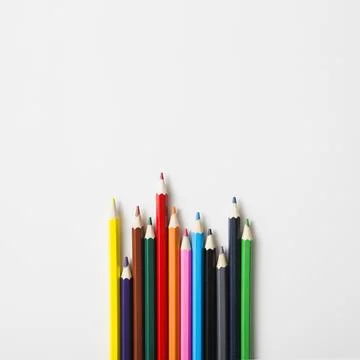 Row sharp colored pencils against white background Stock Photos