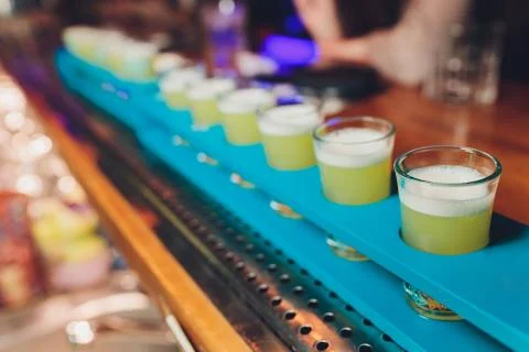 Row of shots on the counter, first is sharp and then they are blurried away. Stock Photos