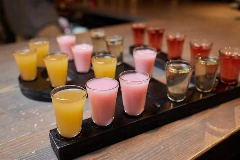 Row of shots on the counter, first is sharp and then they are blurried away. Foto stock