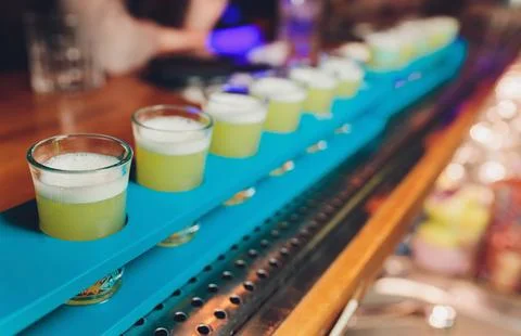 Row of shots on the counter, first is sharp and then they are blurried away. Foto stock