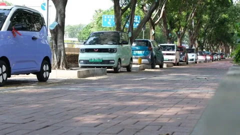 A row of small, compact electric Wuling Hongguang and Baojun mini-EVs in China Stock Footage 289583742