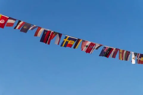 Row of small flags of different countries on a rope Stock Photos