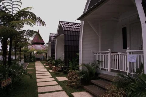 A row of small houses with a path in between them Stock Photos