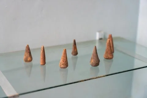 A row of small, round objects are sitting on a glass table. in Chennai Stock Photos