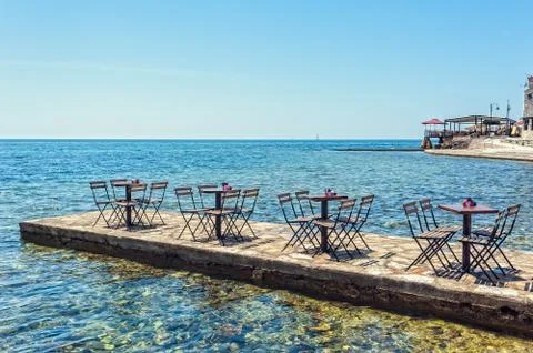 A row of small tables of bars on the pier Stock Photos