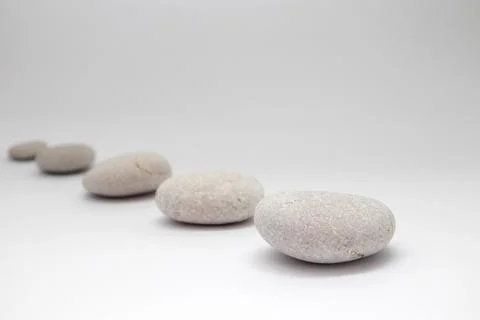 Row of smooth pebbles on white background Stock-Fotos